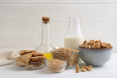 Different natural soy products on white wooden table