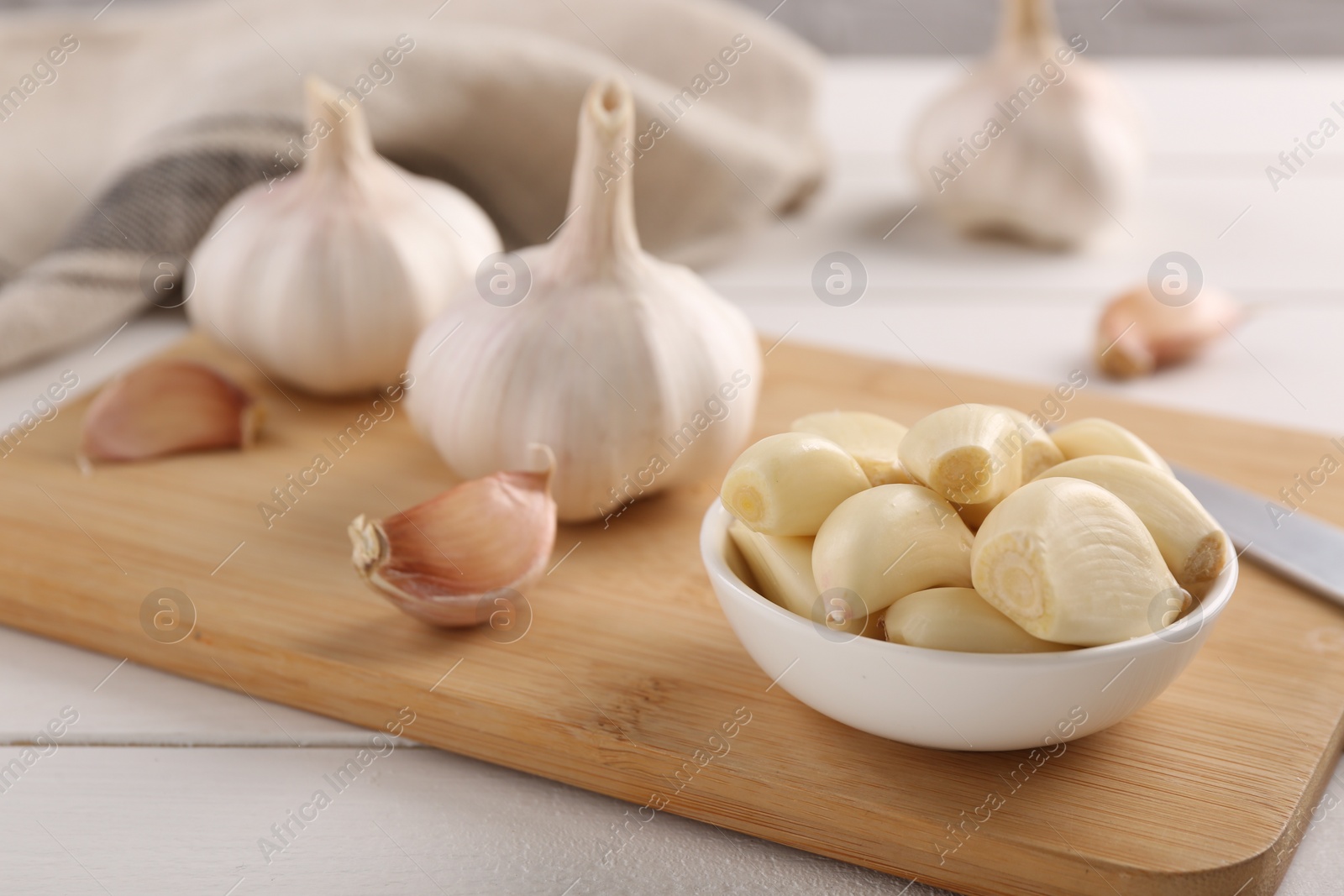 Photo of Fresh garlic on white wooden table, closeup