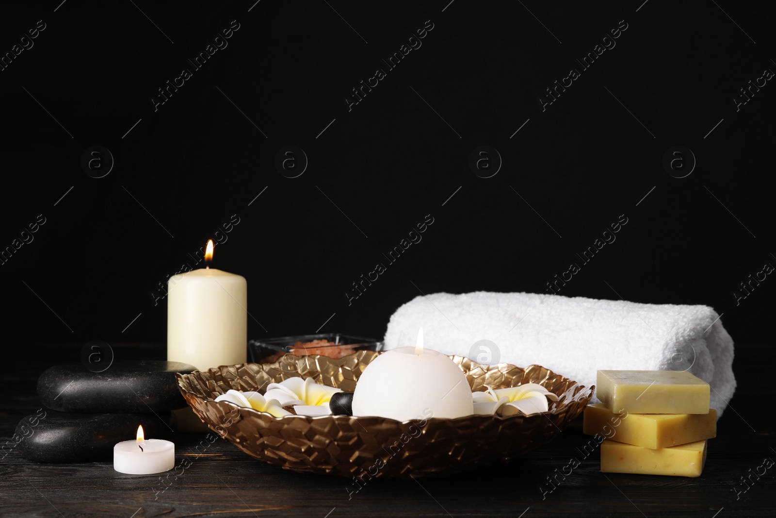 Photo of Beautiful spa composition with candles and flowers on table