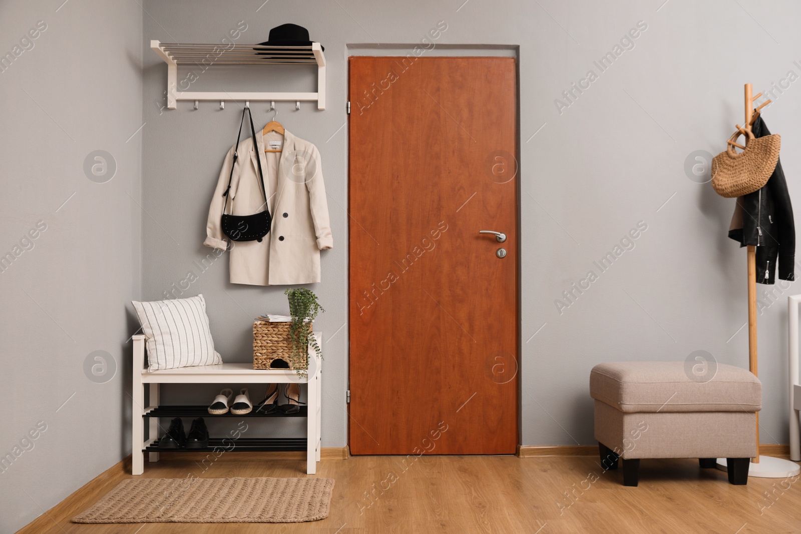 Photo of Modern hallway interior with shoe rack and wooden coat stand