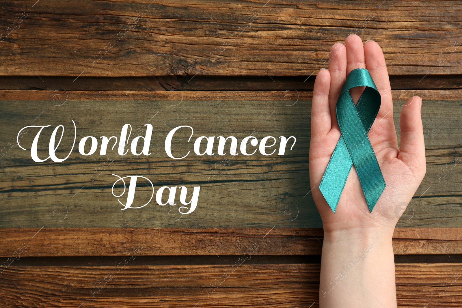 Image of Woman holding green ribbon on wooden background, top view. World Cancer Day