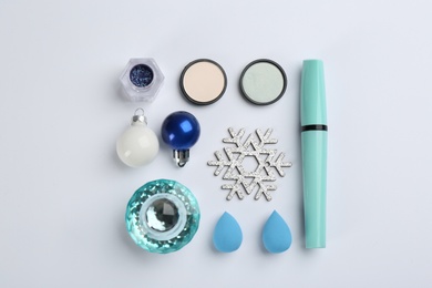 Photo of Flat lay composition with decorative cosmetic products on light background. Winter care