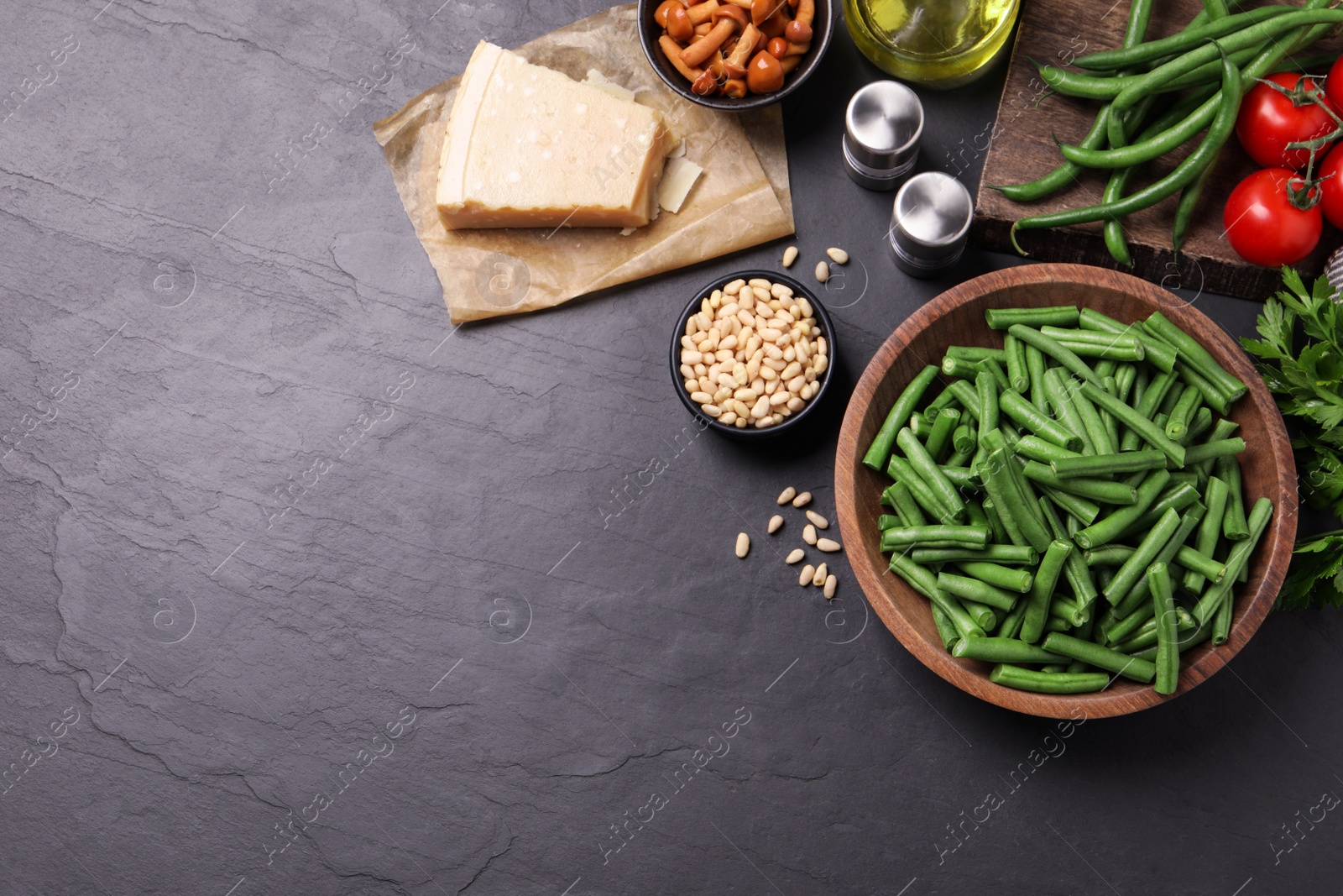 Photo of Fresh green beans and other ingredients on black table, flat lay. Space for text