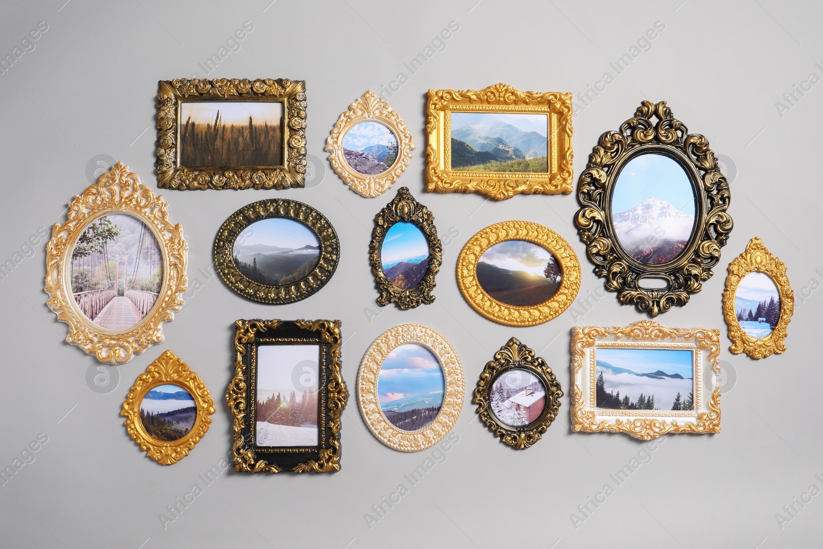 Photo of Vintage frames with beautiful photos of landscapes hanging on light gray wall