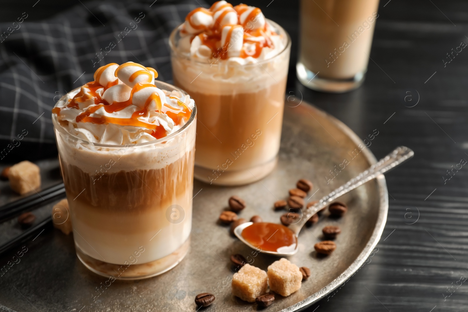 Photo of Glasses with delicious caramel frappe on tray