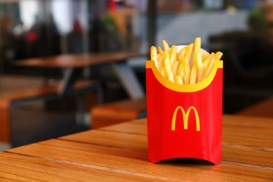 MYKOLAIV, UKRAINE - AUGUST 11, 2021: Big portion of McDonald's French fries on table in cafe. Space for text