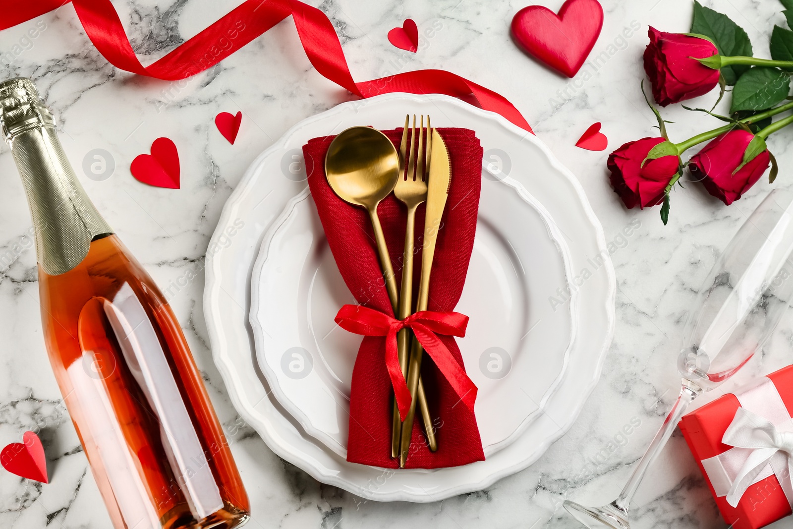 Photo of Beautiful table setting for Valentine's Day dinner on white marble background, flat lay