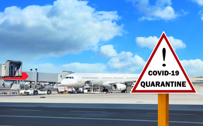 Image of Closure of air traffic during coronavirus outbreak. Airplane and warning sign with inscription QUARANTINE