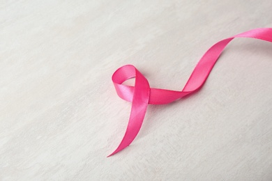 Photo of Pink ribbon on gray background. Breast cancer awareness concept