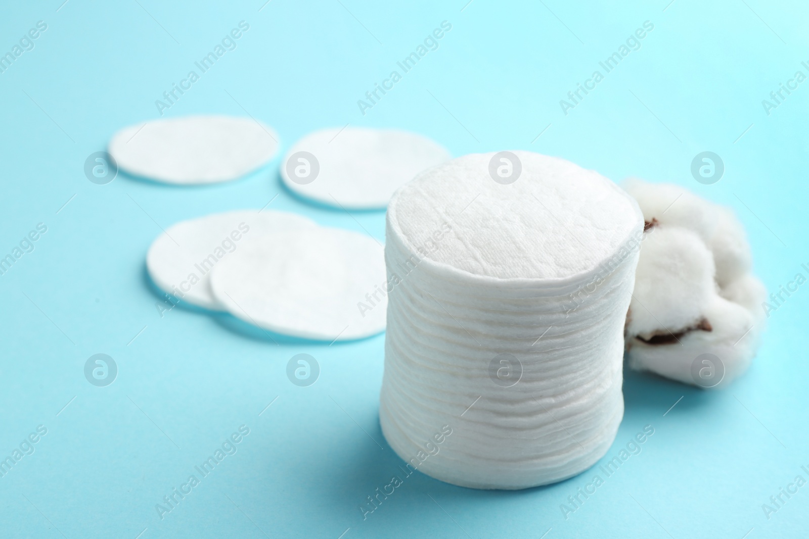 Photo of Cotton pads on color background. Space for text