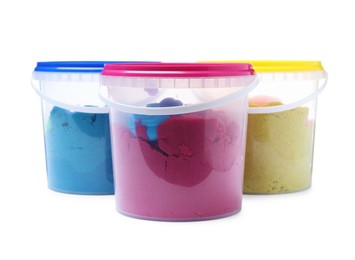 Photo of Kinetic sand and toys in buckets on white background