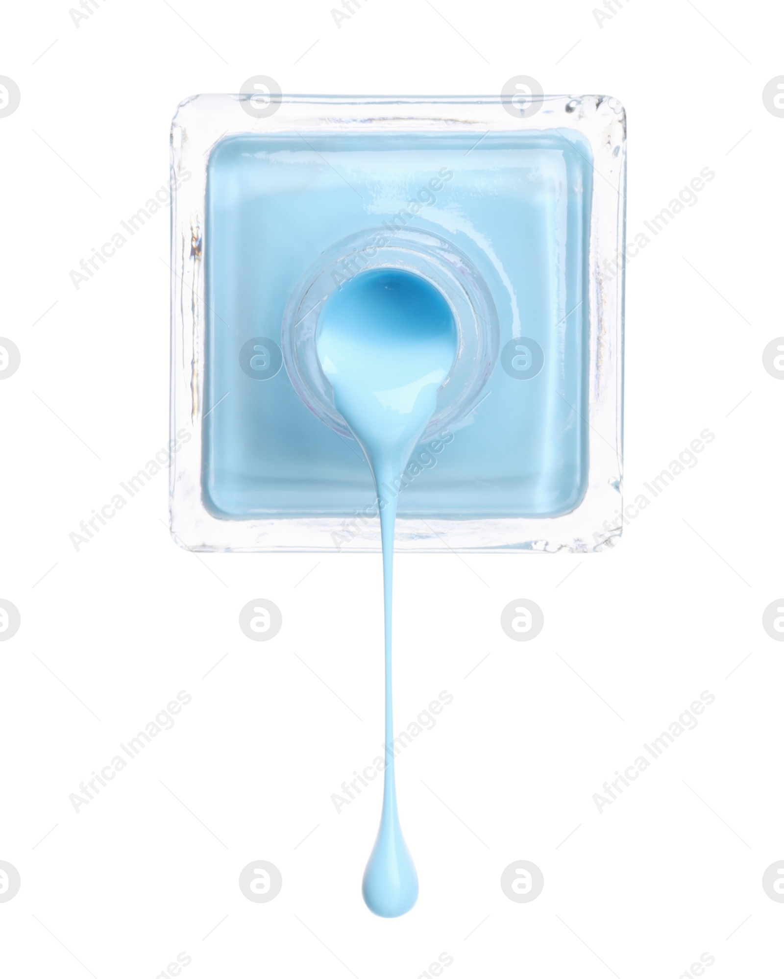 Photo of Light blue nail polish dripping from bottle isolated on white