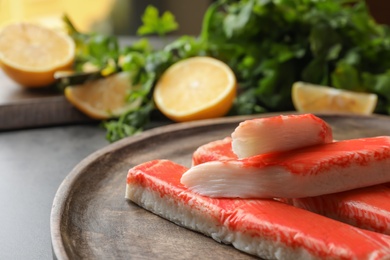 Delicious crab sticks on wooden board, closeup