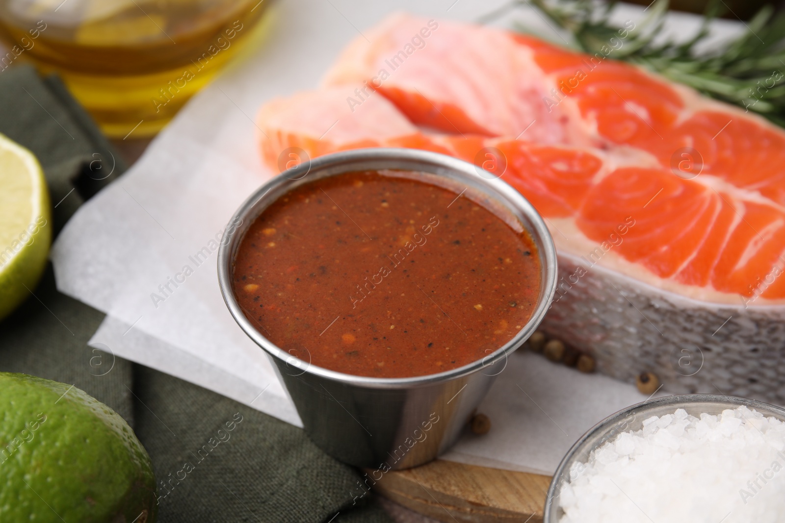 Photo of Tasty fish marinade and products on table, closeup