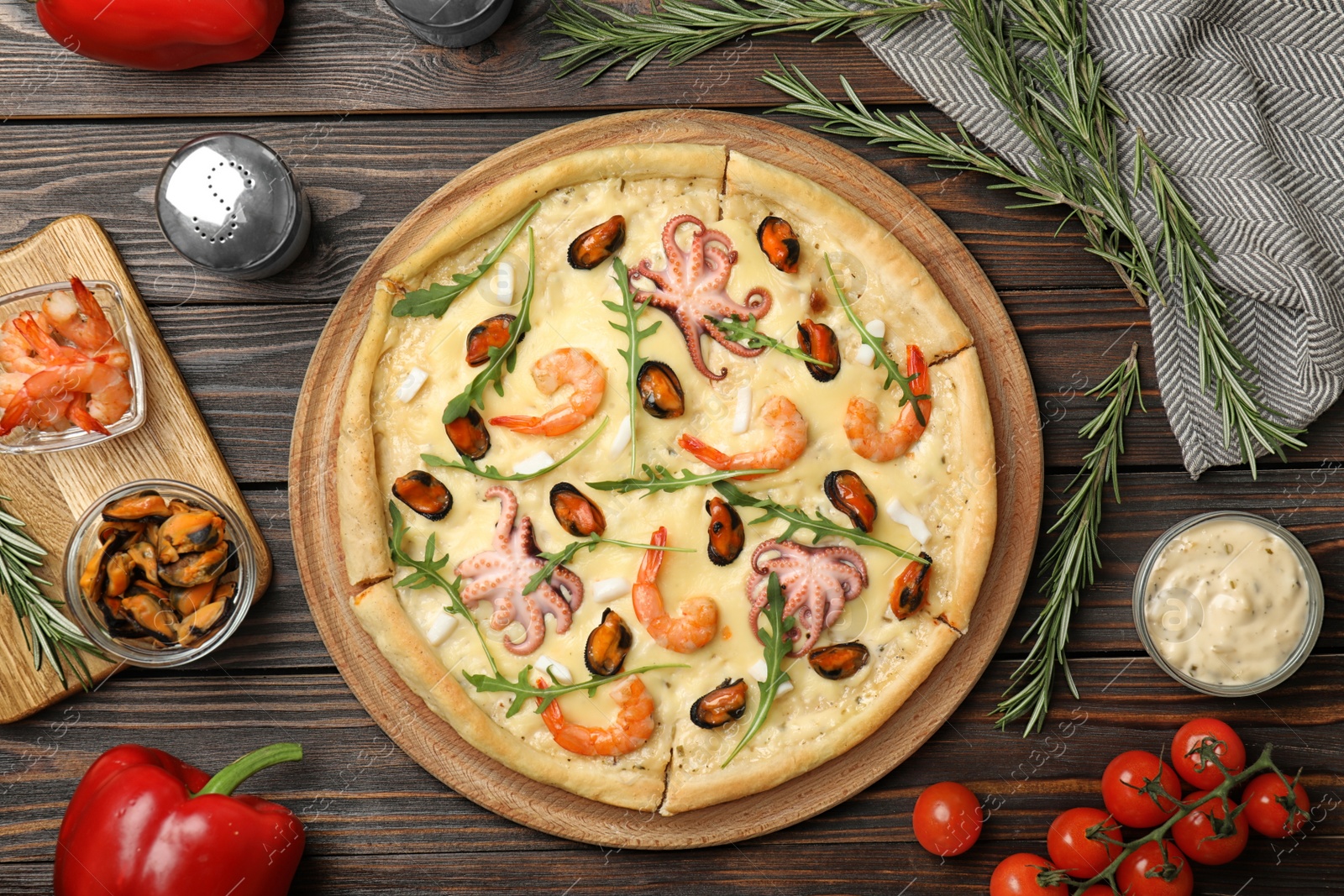 Photo of Delicious seafood pizza on wooden table, flat lay