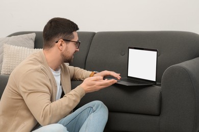Photo of Man having video chat via laptop at home