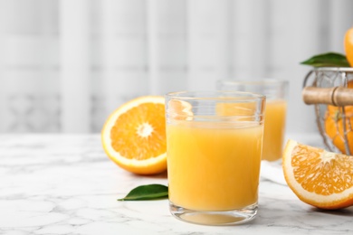 Photo of Composition with orange juice and fresh fruit on table, space for text