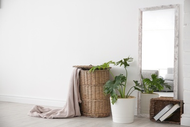 Modern room interior with large mirror and wicker basket