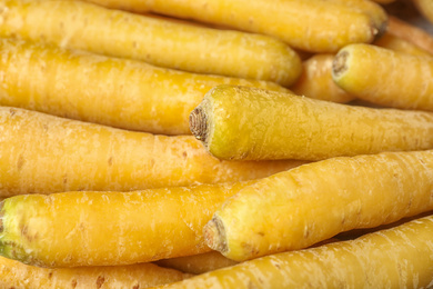 Photo of Many raw yellow carrots as background, closeup