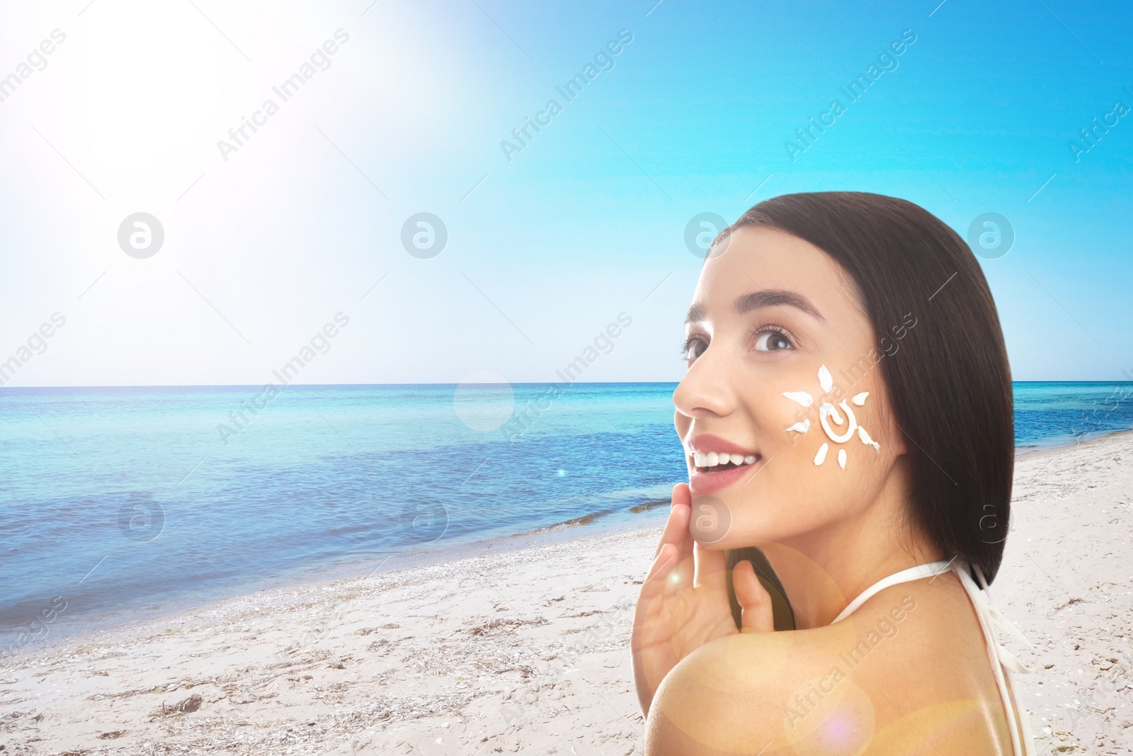 Image of Young woman with sun protection cream on her face at beach, space for text