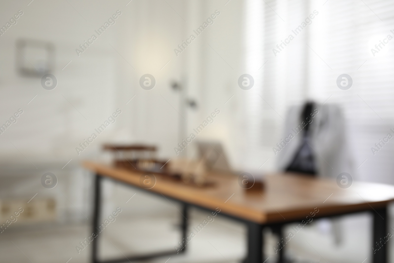 Photo of Blurred view of modern medical office with doctor's workplace. Interior design