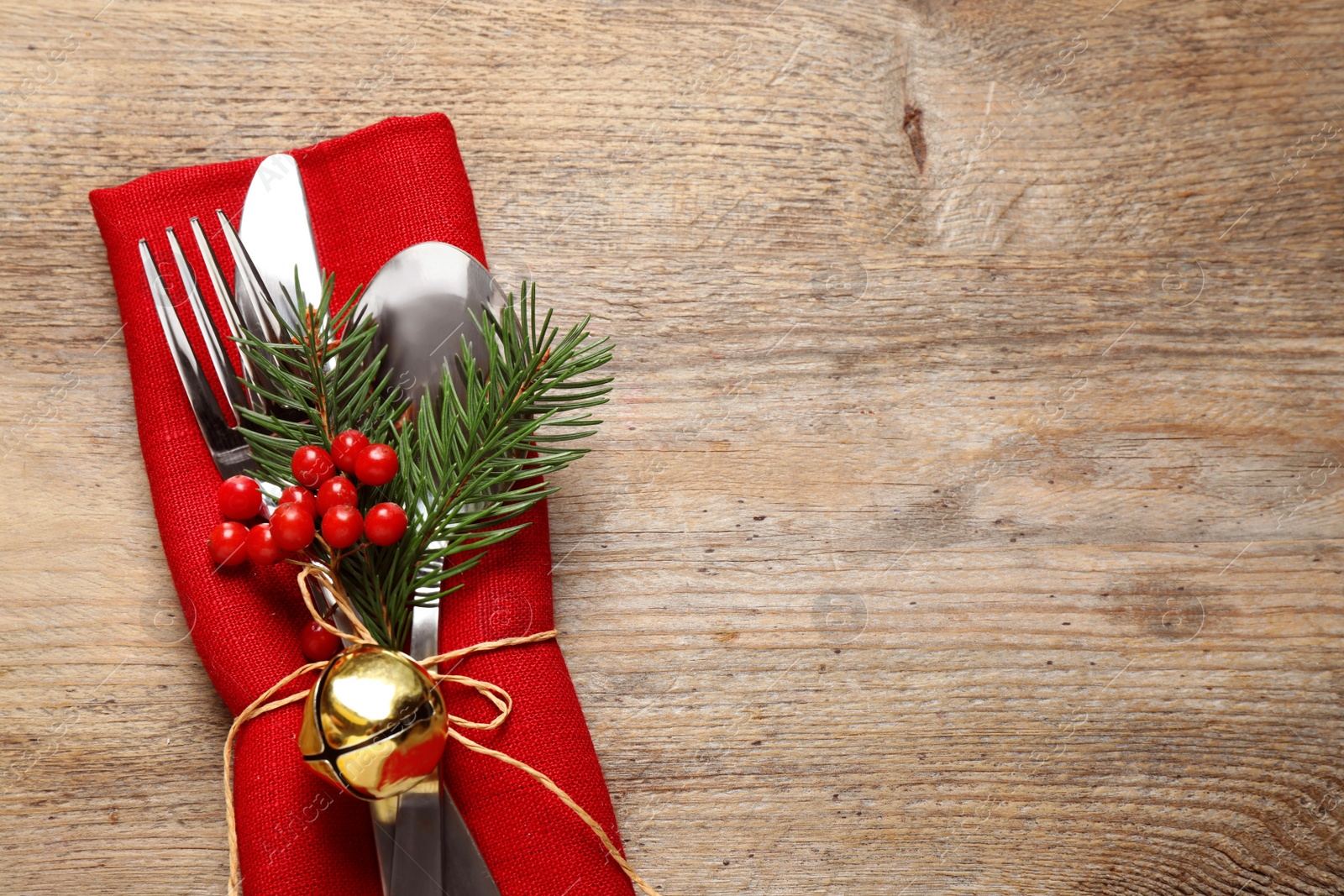 Photo of Cutlery set on wooden table, top view with space for text. Christmas celebration