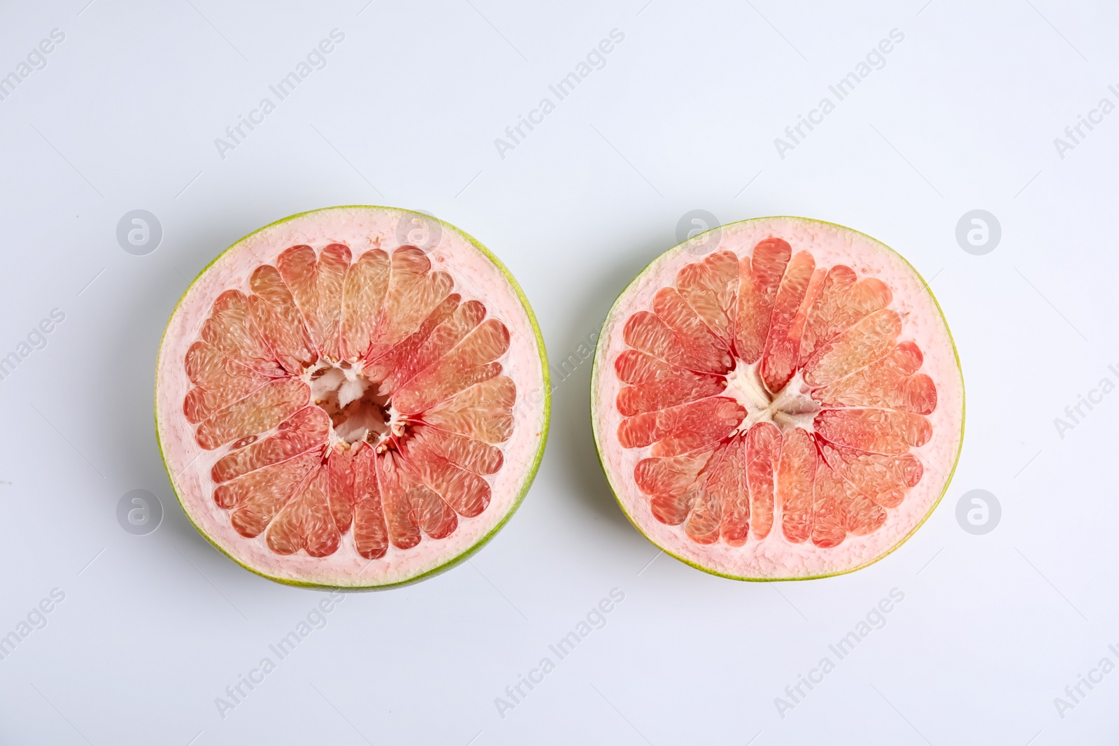 Photo of Fresh cut pomelo fruit on white background, top view