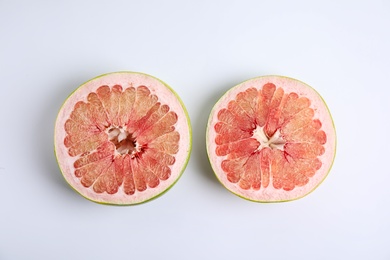 Photo of Fresh cut pomelo fruit on white background, top view