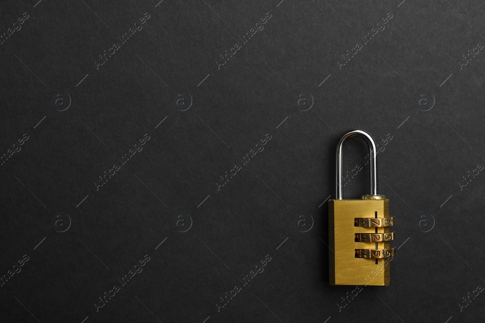 Photo of Modern combination lock on black background, top view. Space for text