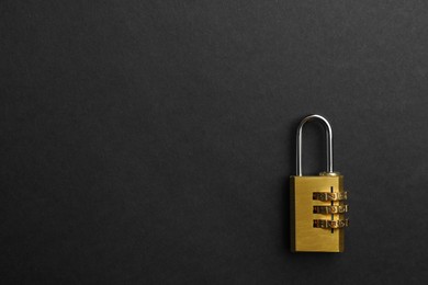 Modern combination lock on black background, top view. Space for text