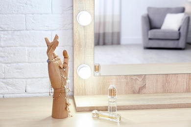 Photo of Makeup mirror on table near white wall in dressing room