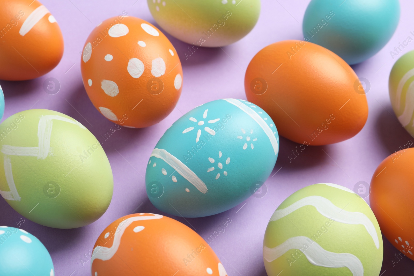 Photo of Many beautiful painted Easter eggs on color background, closeup