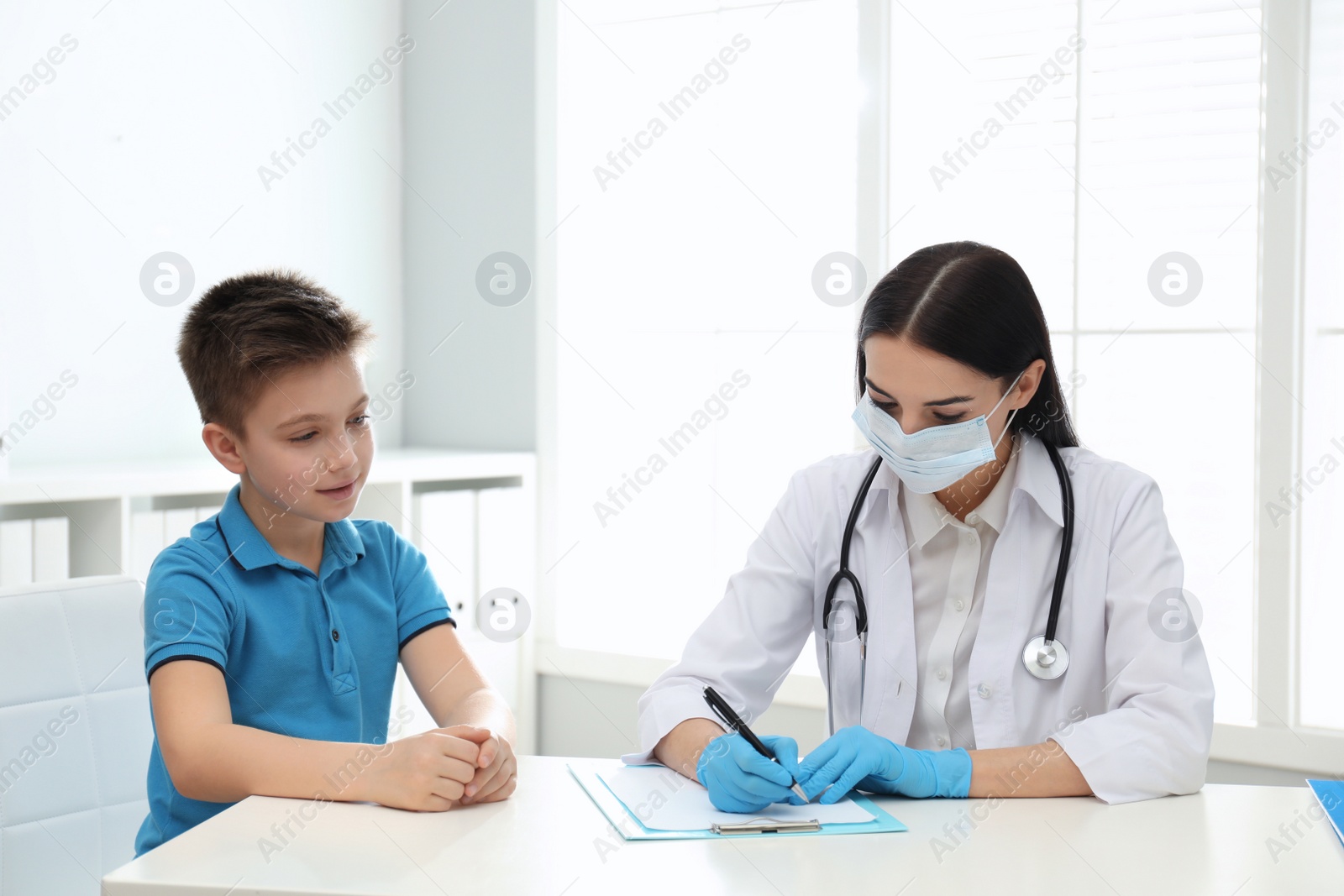 Photo of Doctor examining little patient before vaccination in clinic
