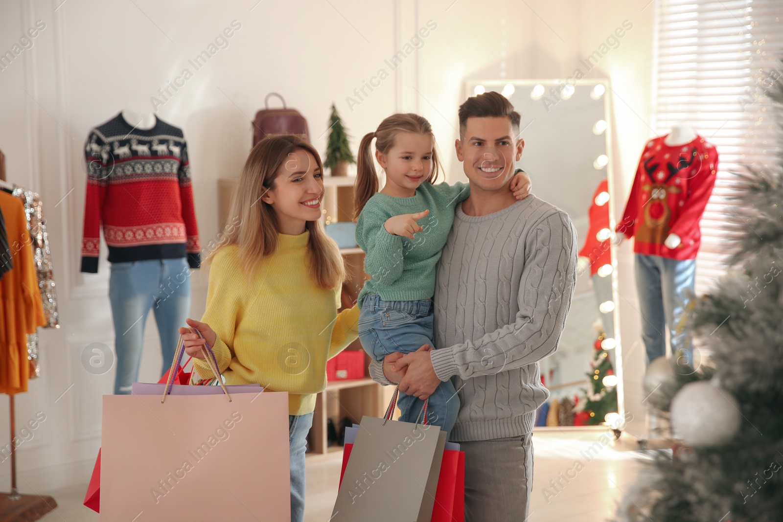 Photo of Happy family doing Christmas shopping in store