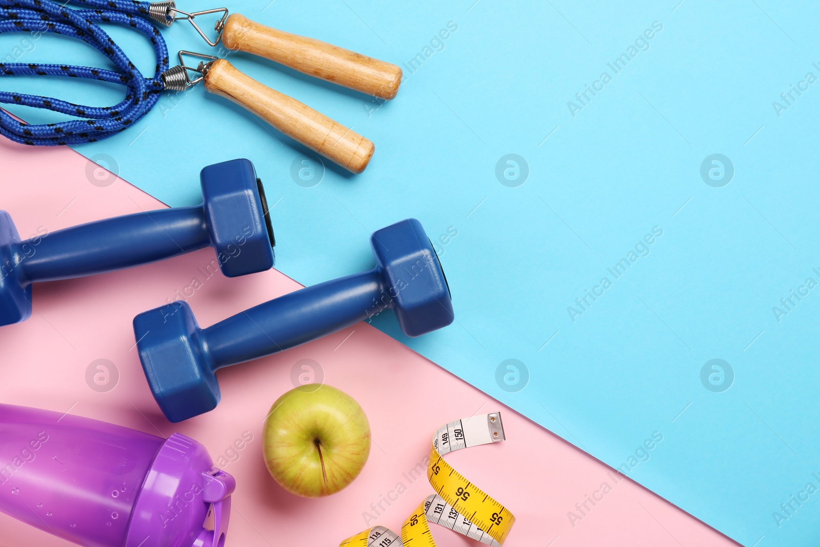 Photo of Flat lay composition with dumbbells on color background, space for text