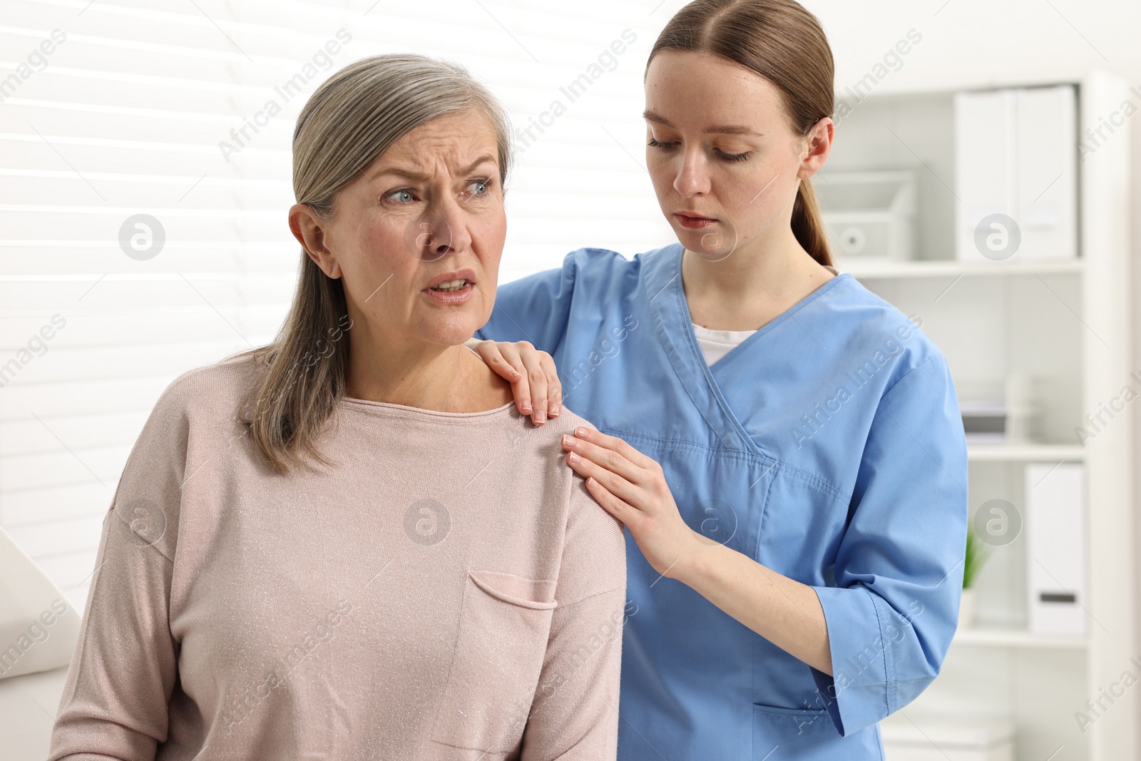 Photo of Arthritis symptoms. Doctor examining patient with shoulder pain in hospital