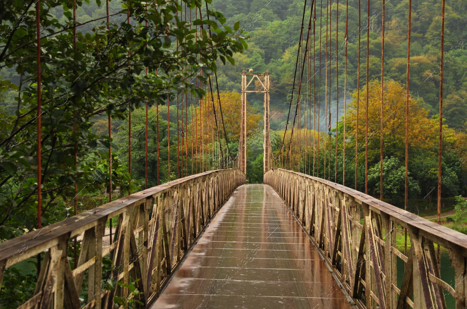 Photo of Beautiful view on rusty metal bridge over river in mountains