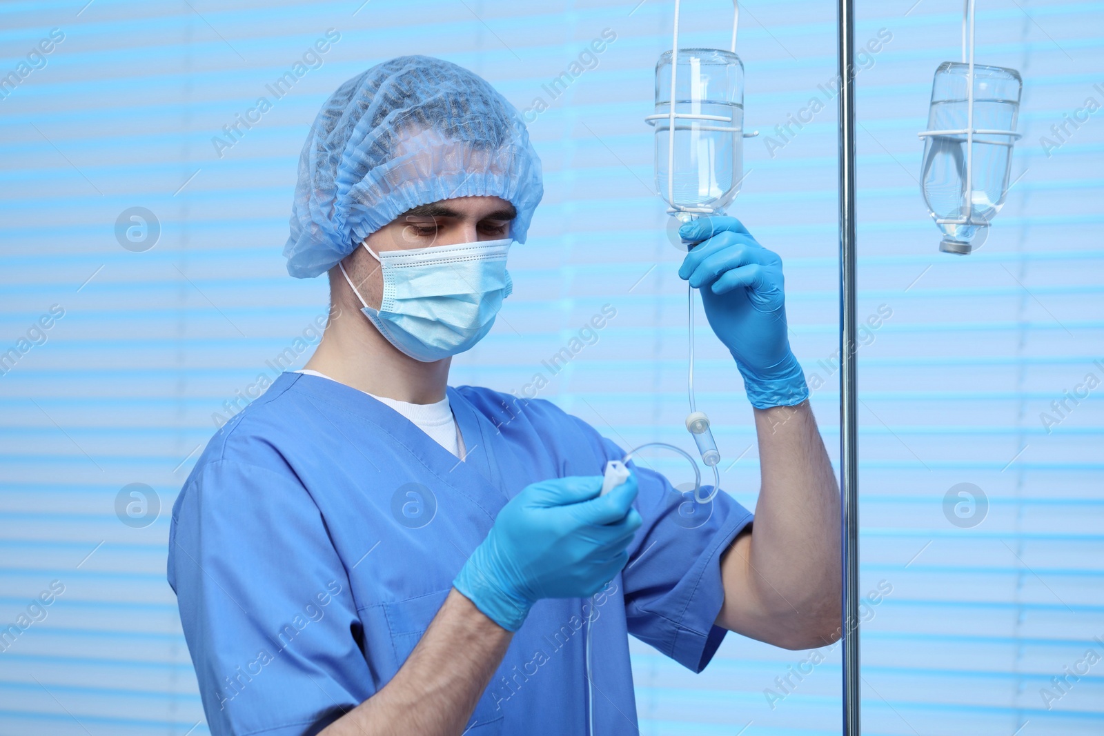 Photo of Nurse setting up IV drip in hospital