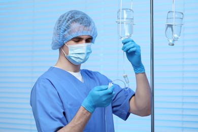 Photo of Nurse setting up IV drip in hospital