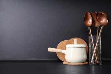 Composition with kitchenware on table against grey background. Space for text