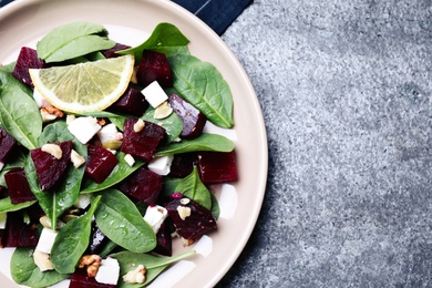 Delicious beet salad served on grey table, top view