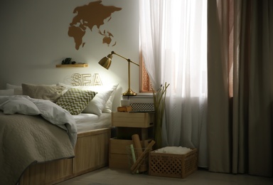 Photo of Modern eco style interior with wooden crates and comfortable bed