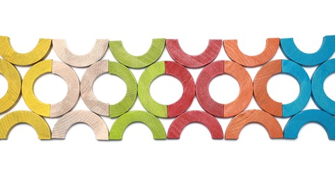 Colorful wooden pieces of play set isolated on white, top view. Educational toy for motor skills development
