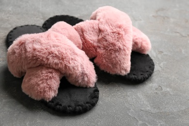 Photo of Pair of soft slippers on grey background