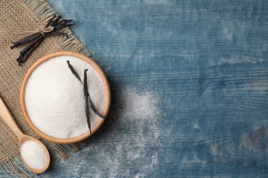 Photo of Flat lay composition with vanilla sugar on wooden background, top view