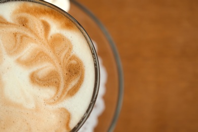 Cup of aromatic coffee on wooden background