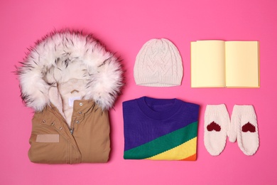 Set of warm clothes and empty notebook on color background, flat lay. Winter vacation