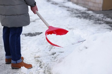 Man removing snow with shovel outdoors, closeup