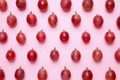 Photo of Flat lay composition with fresh ripe grapes on pink background