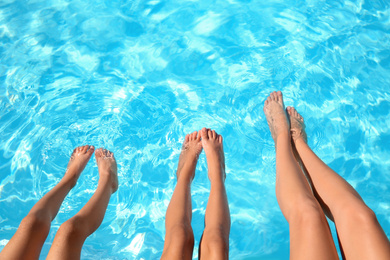 Photo of Woman and her children in swimming pool, closeup. Family vacation